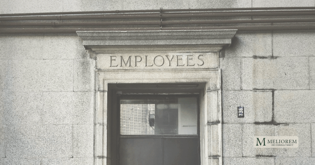 An old building with a stone doorway with the word employees engraved into it. Stepping into a new world with the employment rights bill.